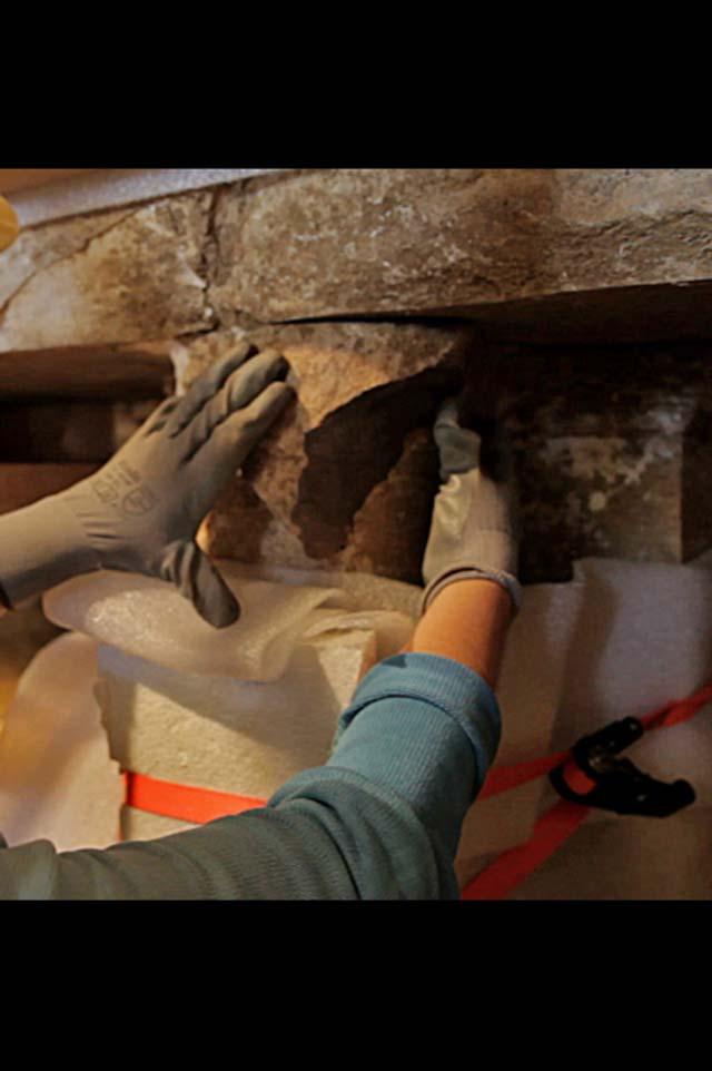 Conservators restoring the broken face of the East Caryatid